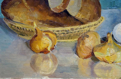 Oil painting of golden-brown bread loaf in woven wicker basket on table