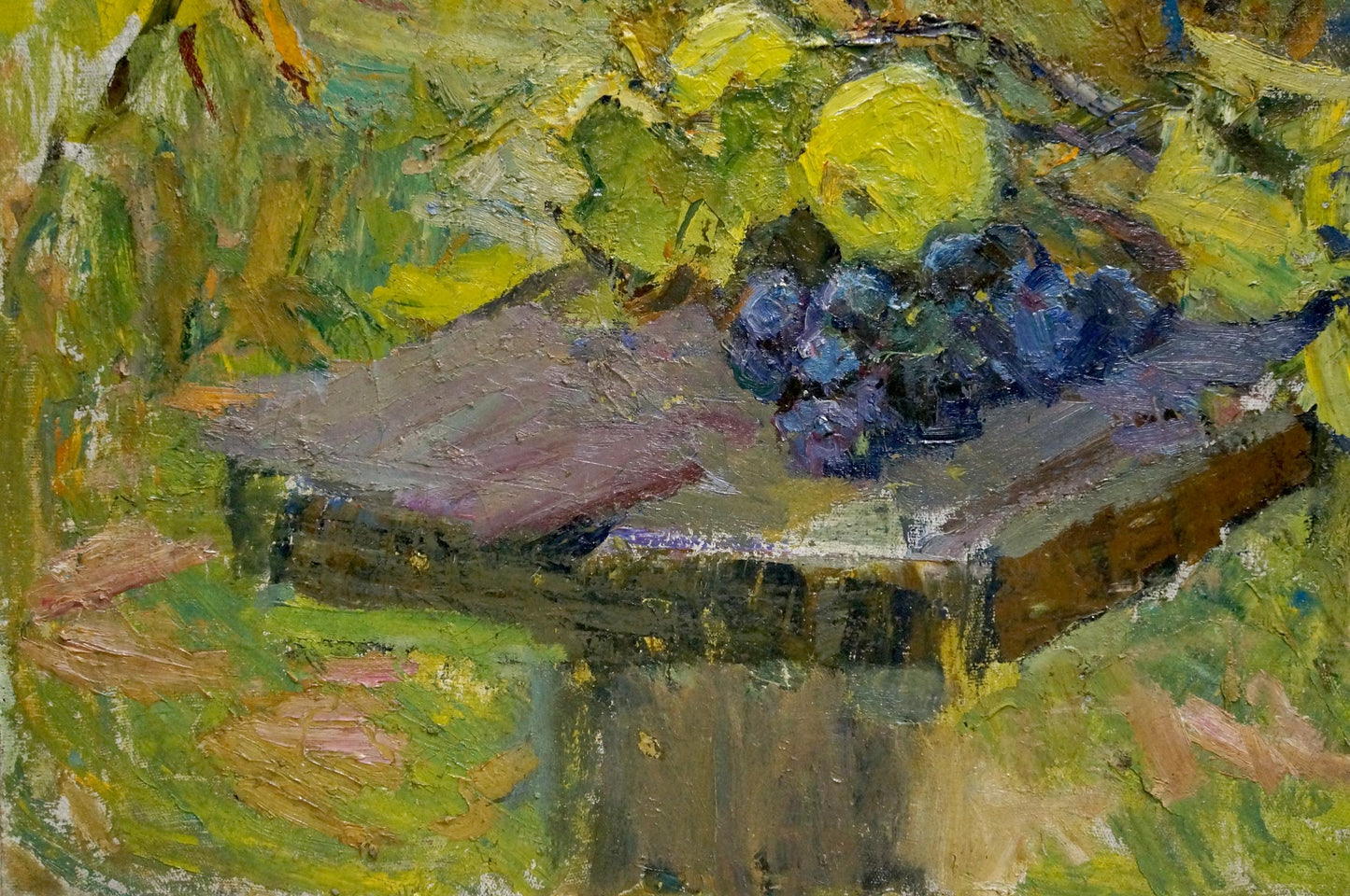 A cluster of dark purple grapes rests on a rustic wooden table, painted with expressive brushstrokes in an impressionistic style.