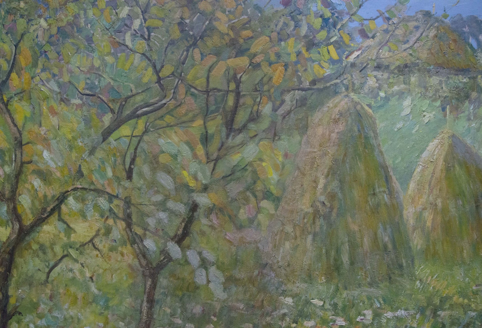 Oil painting At the village: tall conical hay bales in sunlit field under trees