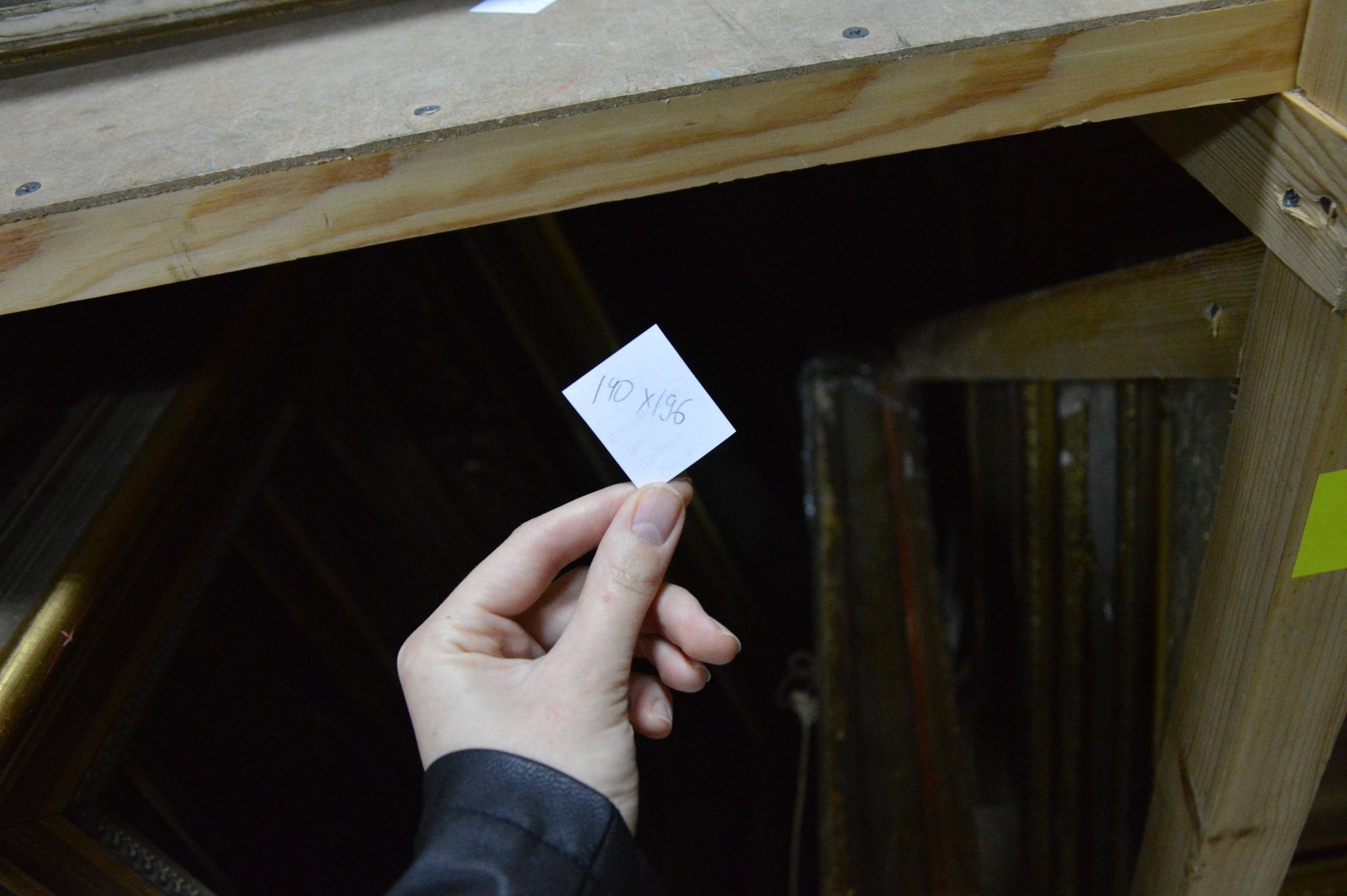 Handheld white tag on back of Oil painting Lilac near the window showing 10 x 9.5 inches
