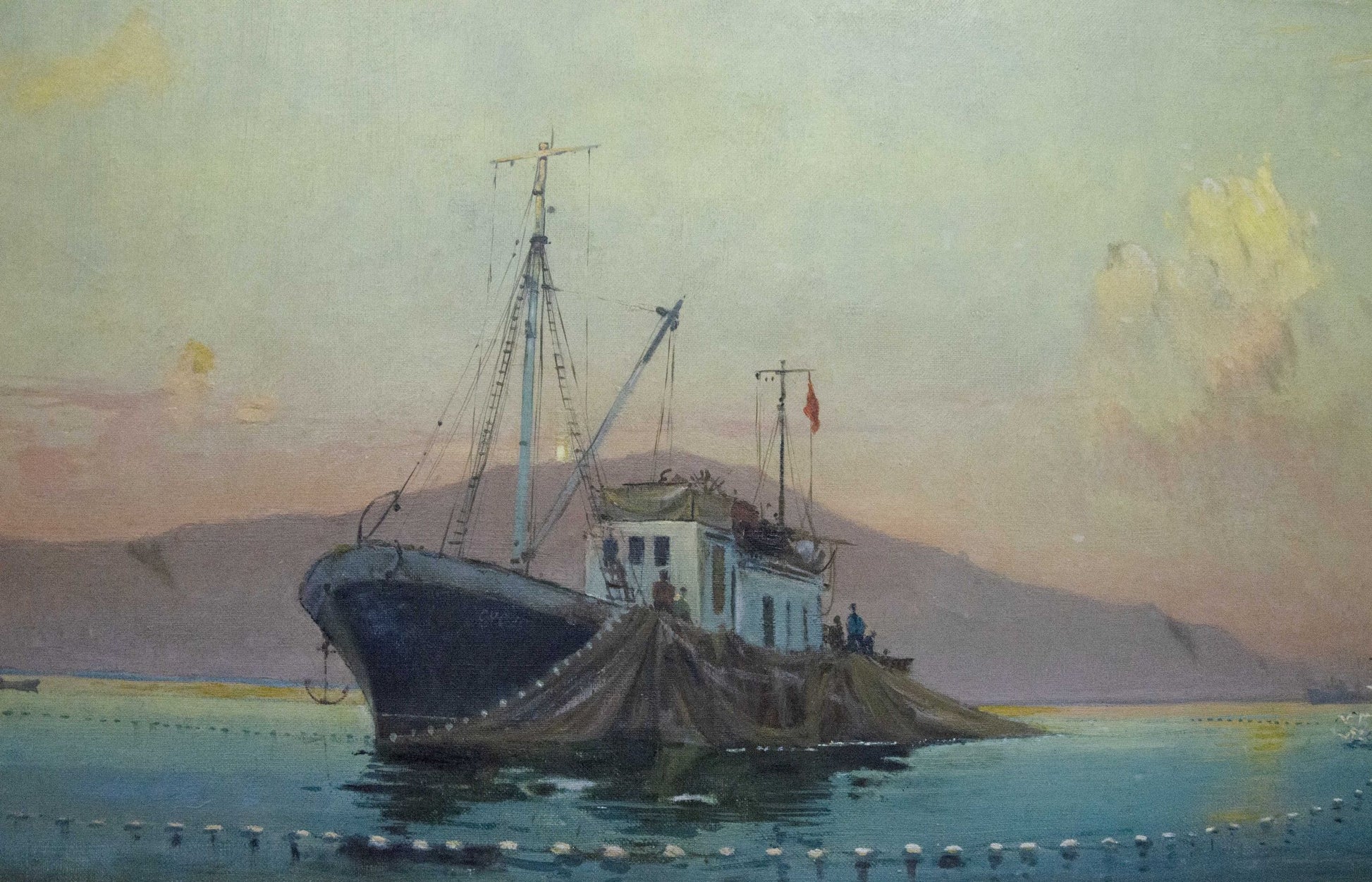 Oil painting by Peter Kuzmich Stolyarenko: dark fishing boat moored by rocky shore at twilight