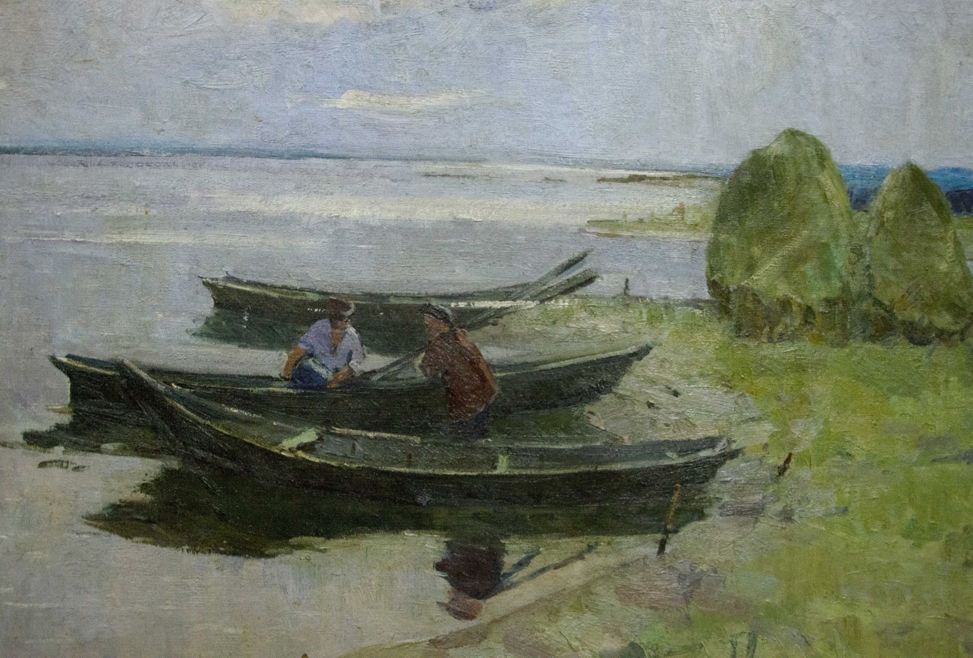 Oil painting Near the shore by Sevastyanov Victor Grigorievich: dark rowboats with two figures