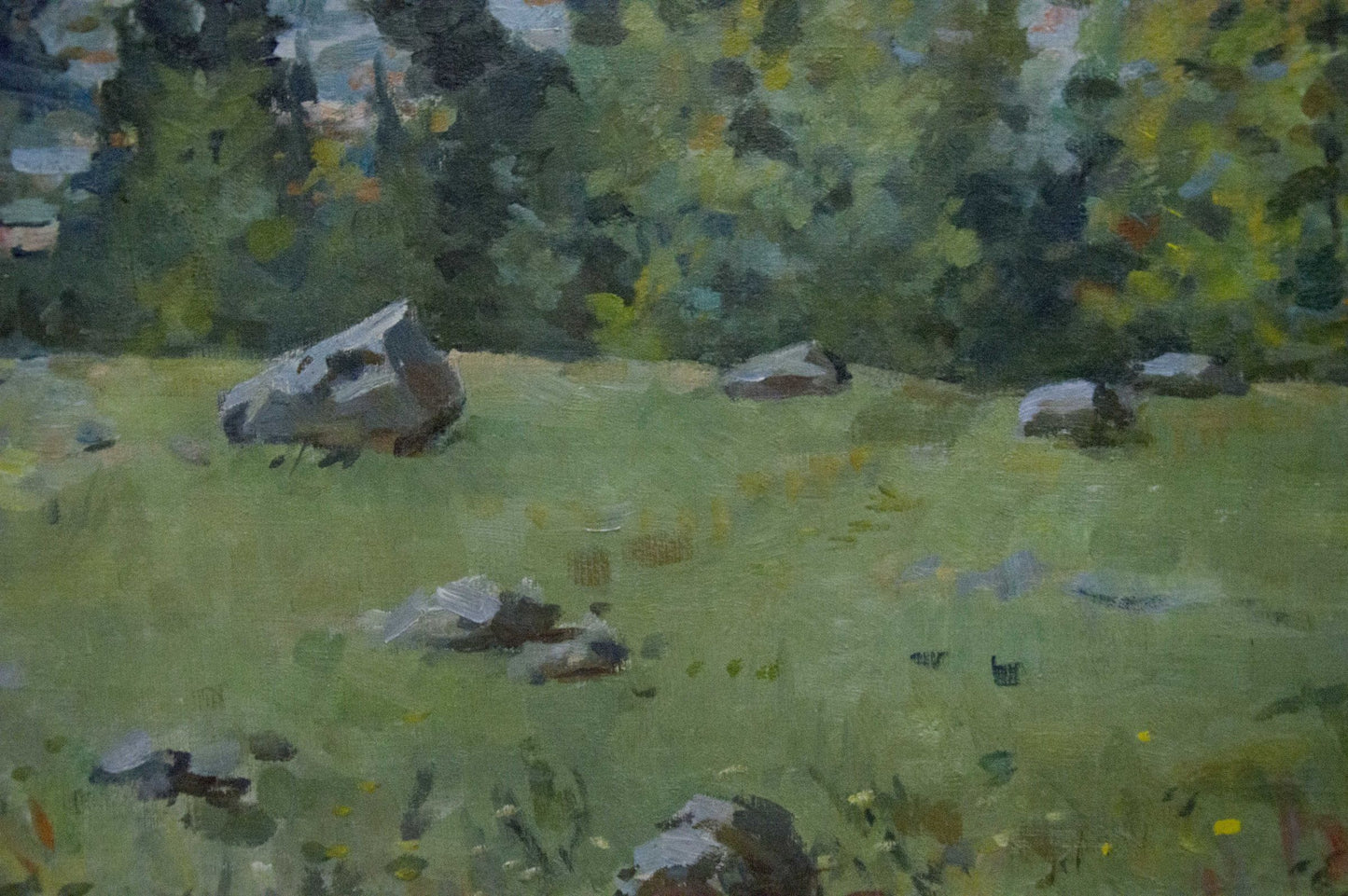 Oil painting of gray rocks in green grassy field by wooded mountainscape artist