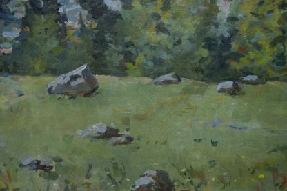 Oil painting of gray rocks in green grassy field by wooded mountainscape artist
