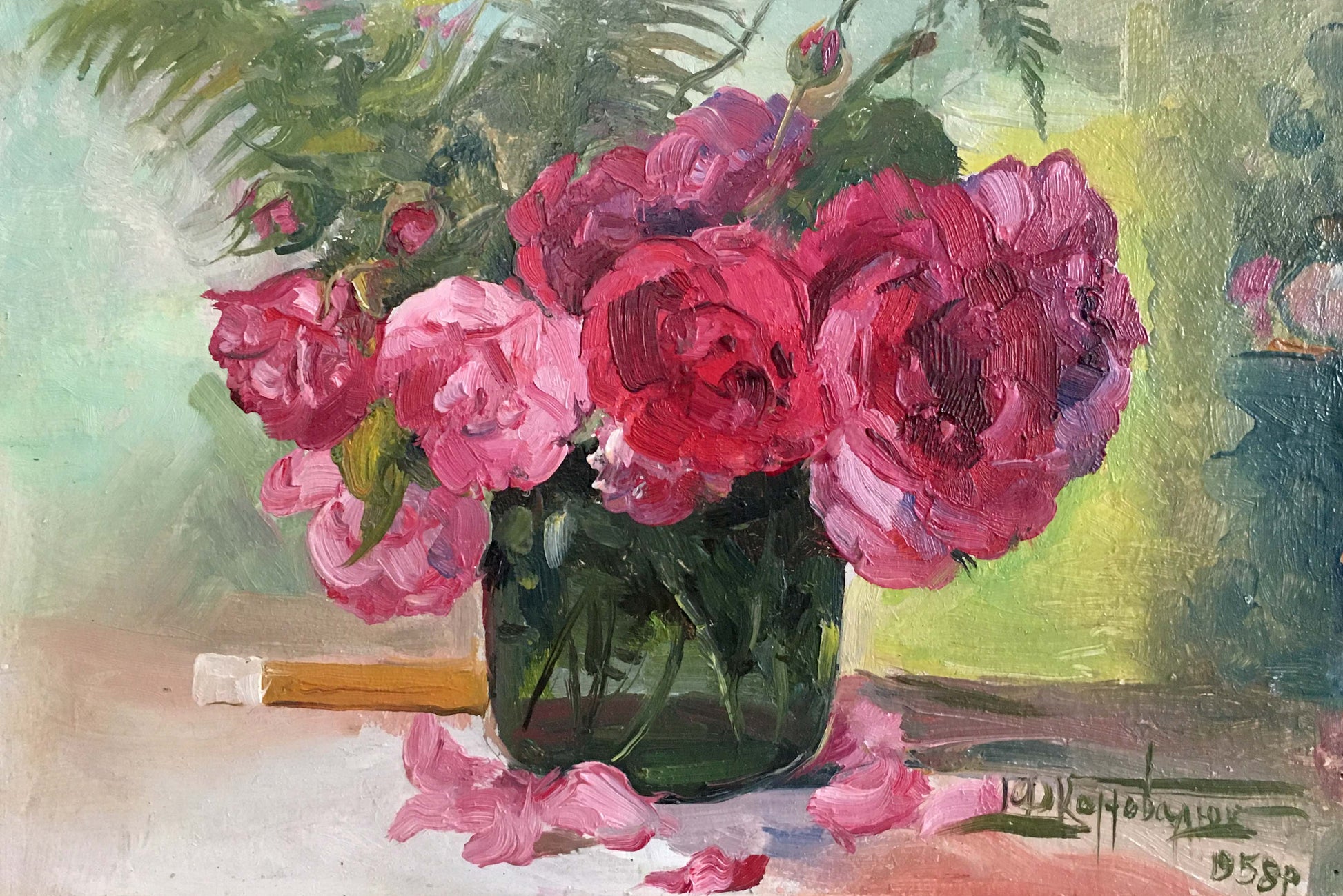A vibrant bouquet of deep pink and magenta roses in a dark green glass vase.