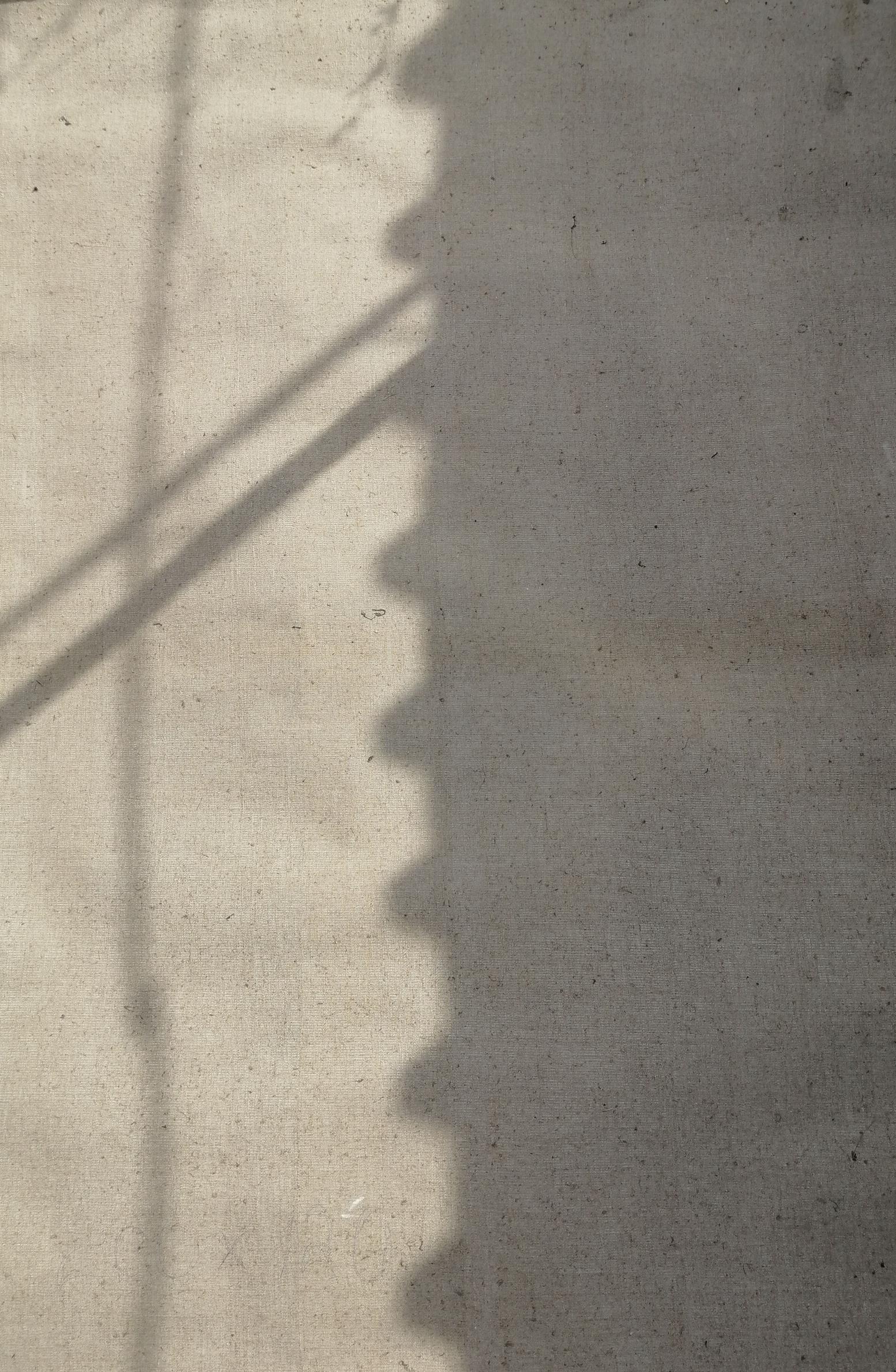 Textured light gray concrete wall with Lenin portrait shadows