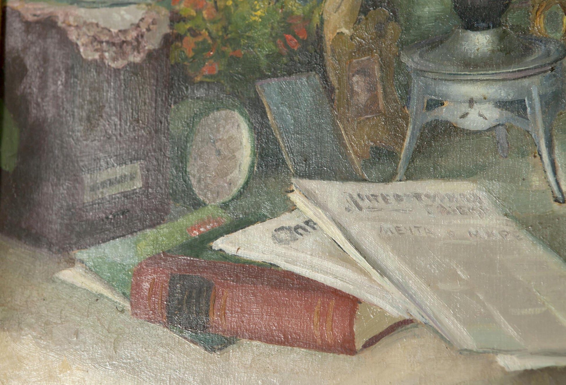 Red leather book with gold lettering open on papers and green books in oil painting still life