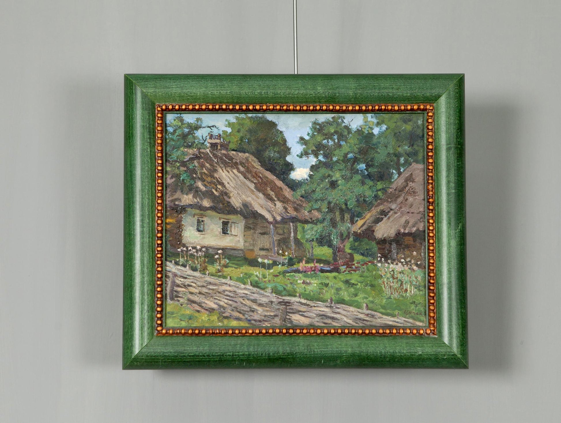 Original green-framed painting by Soviet artist Zyupka I of rustic thatched cottages