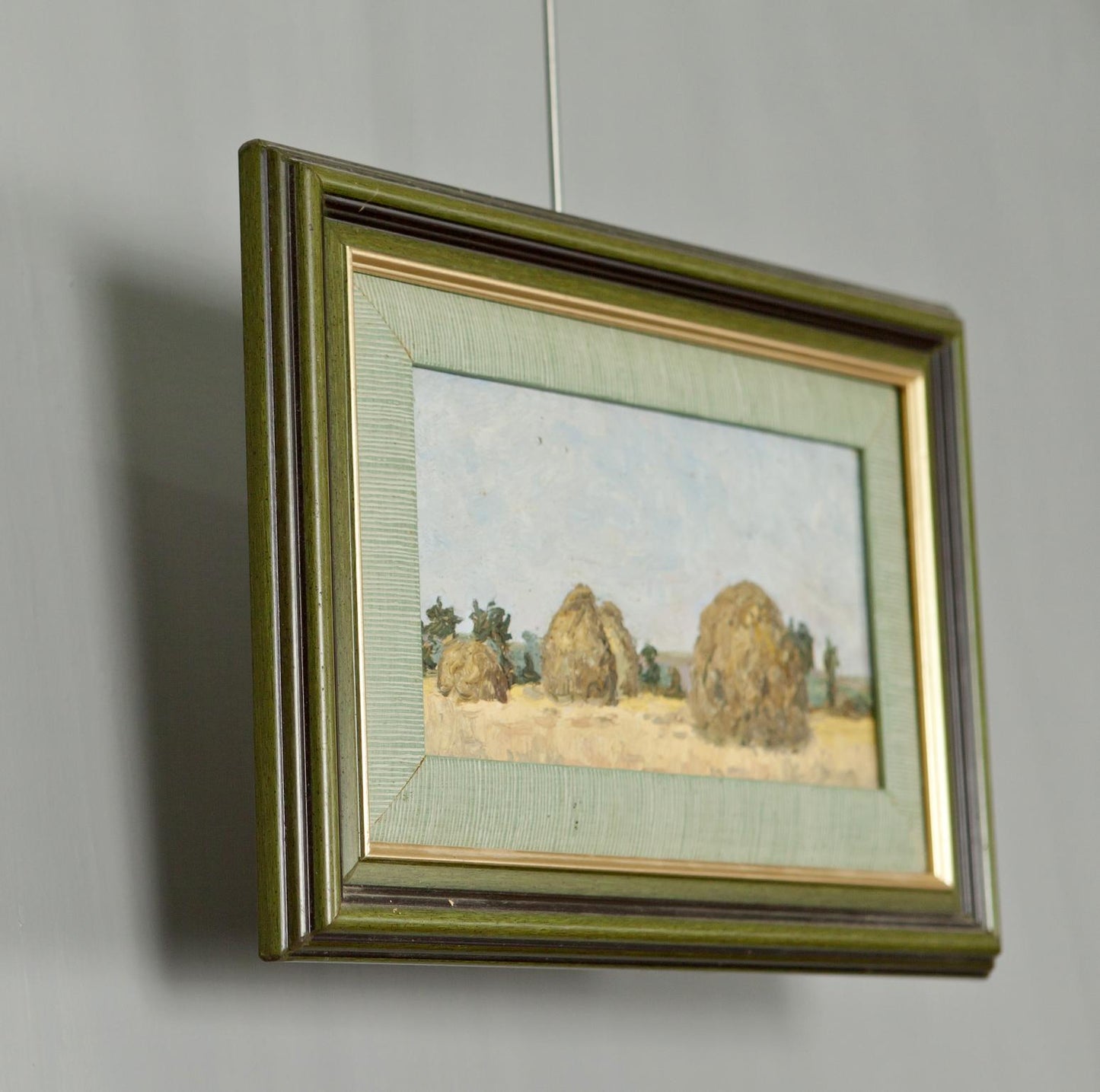 Antique Landscape in Oil painting of impressionistic haystacks in olive-green frame