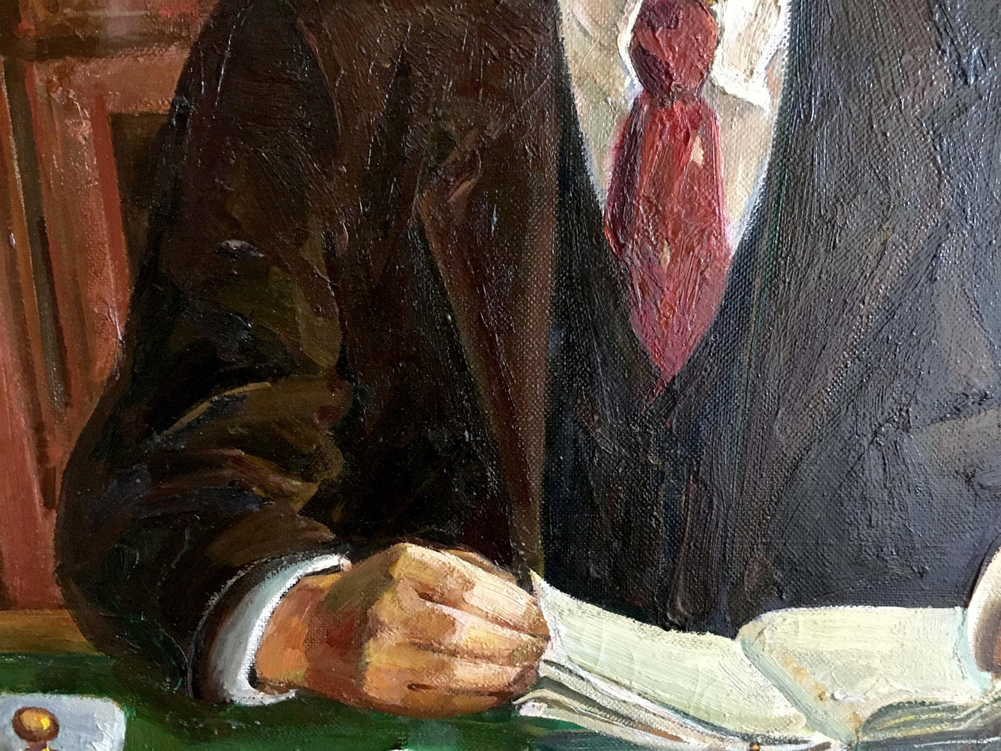 Oil painting of Lenin at table in brown suit and red tie