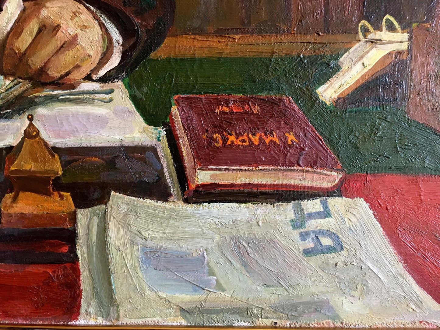 Back of maroon hardcover Oil painting Lenin at the table book with gold spine lettering on textured surface