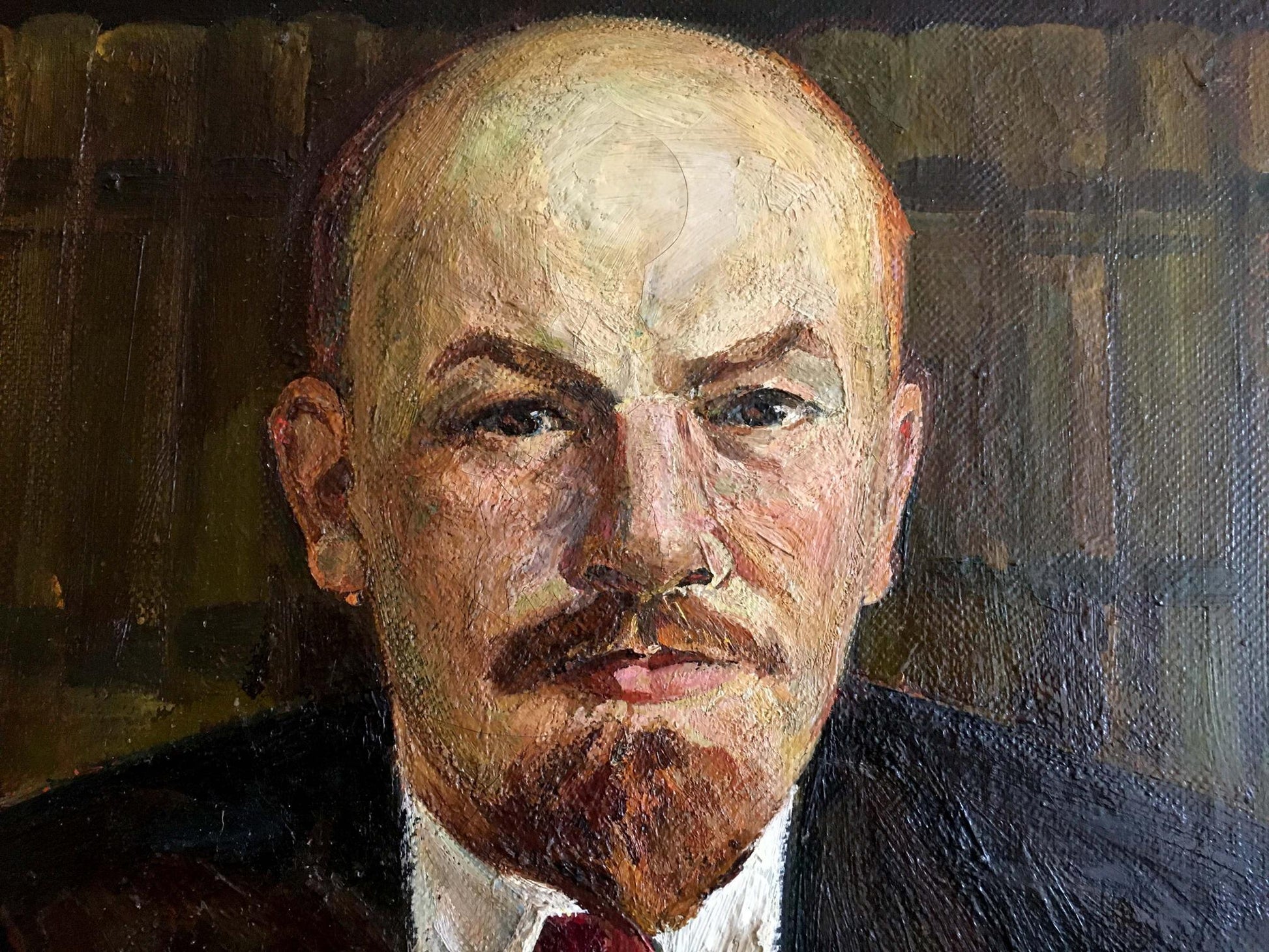 Oil painting of Vladimir Lenin at the table, bald head, red-brown mustache