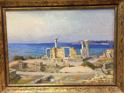 Antique oil painting of ancient stone ruins by sea in gilded frame