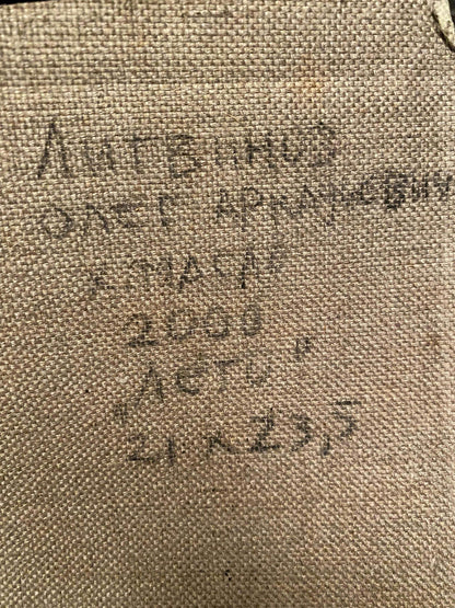 Back of Oleg Litvinov oil painting on beige woven fabric with faded Cyrillic text