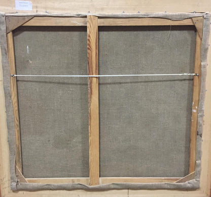 Back of framed oil painting canvas with light wood bars and gray backing
