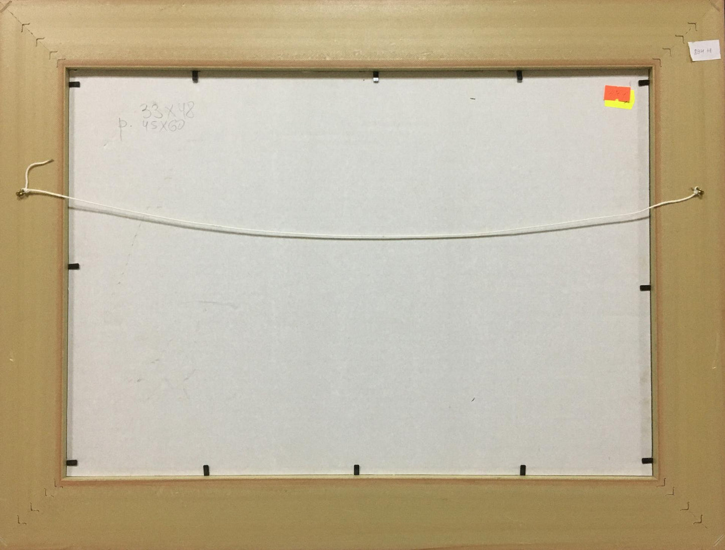 Back of beige wooden frame with black brackets for Trokhimenko oil painting