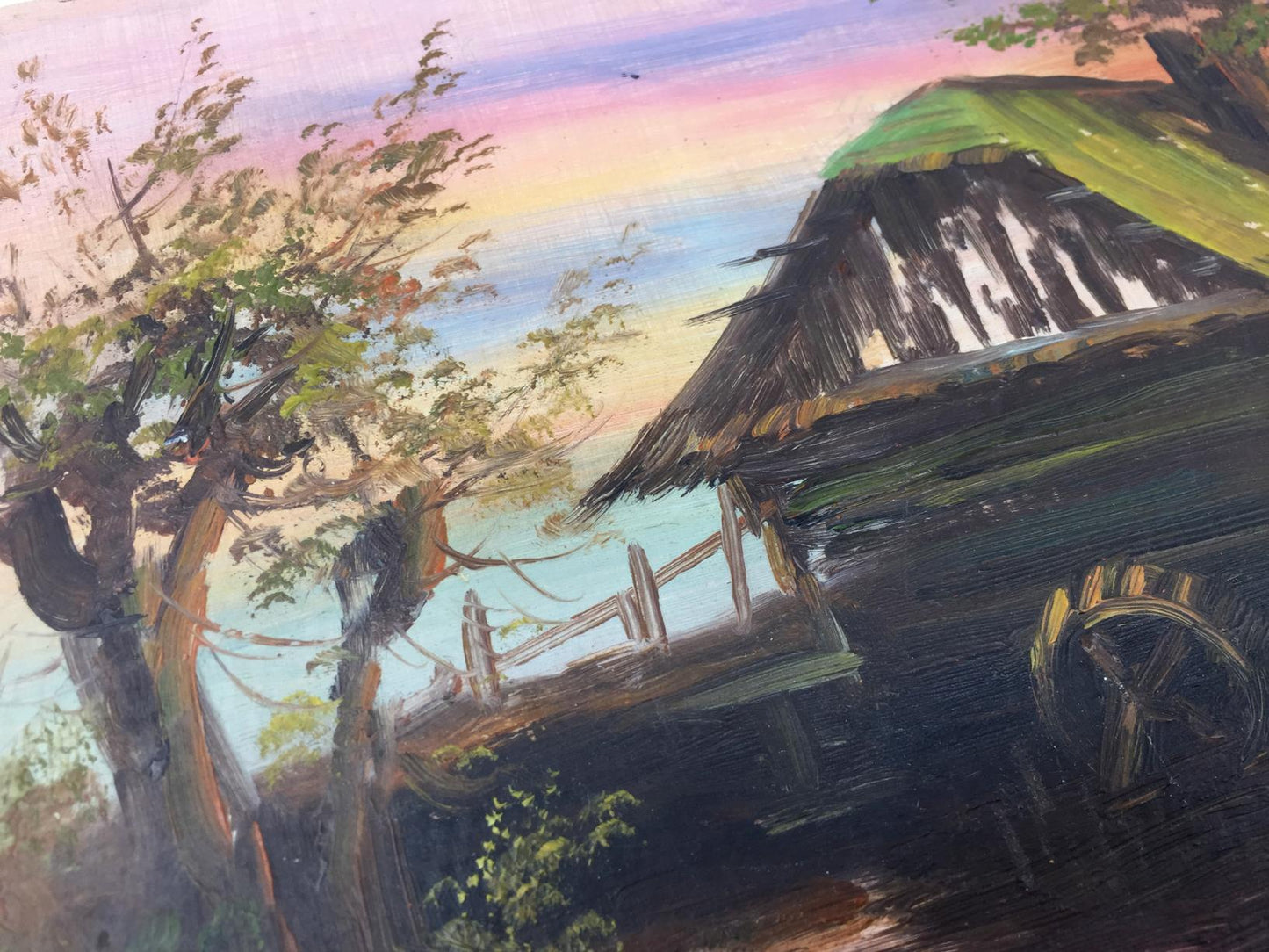 Oil painting of rustic thatched cottage in swamp under pink sky