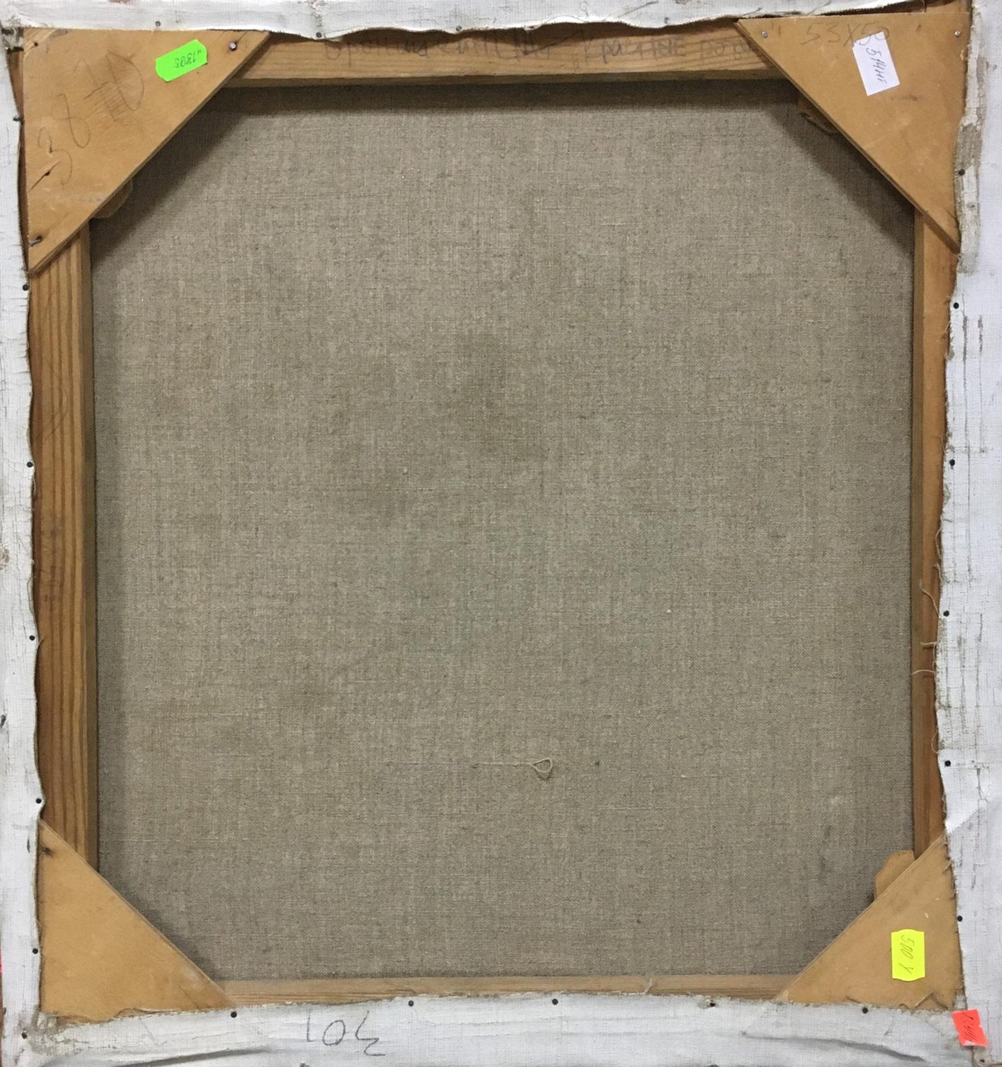 The back of a square canvas painting with a beige linen backing and wooden stretcher bars.