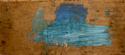 Back of weathered wooden canvas with faded blue paint and markings by Buryachok