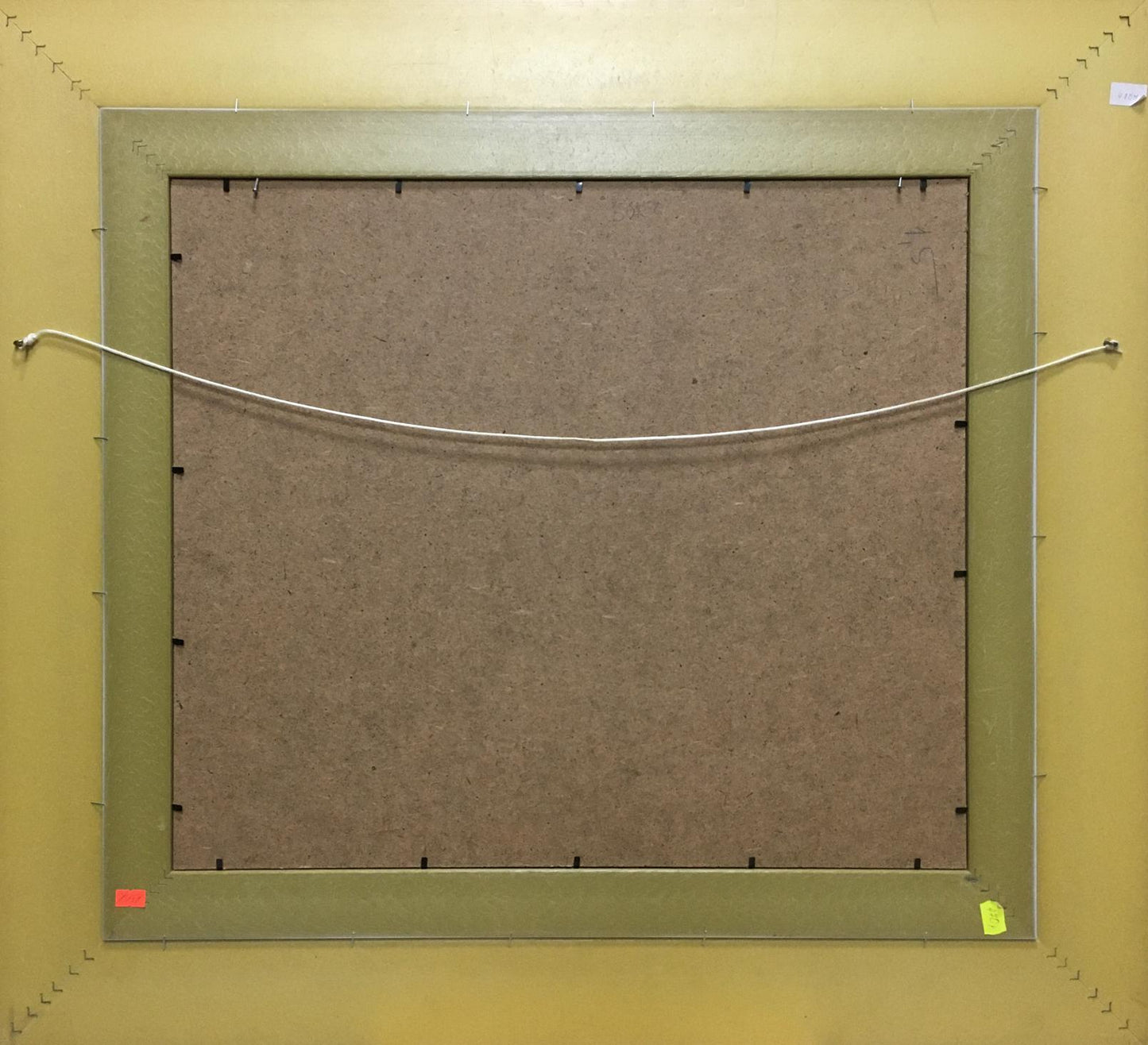 Back of Oil painting Flowers Petr Volsky with olive green frame, brown particle board backing, white hanging wire