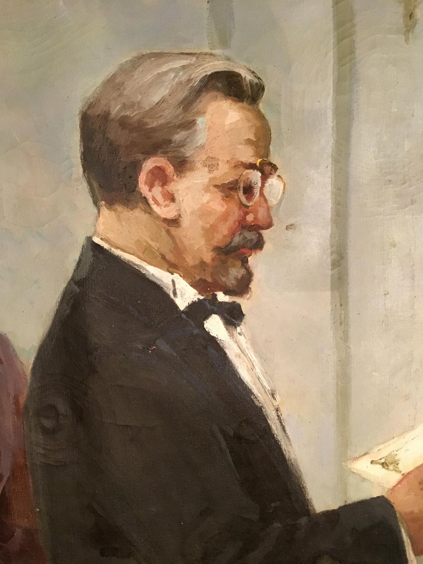 Oil painting graduation portrait of man in profile with glasses and tuxedo