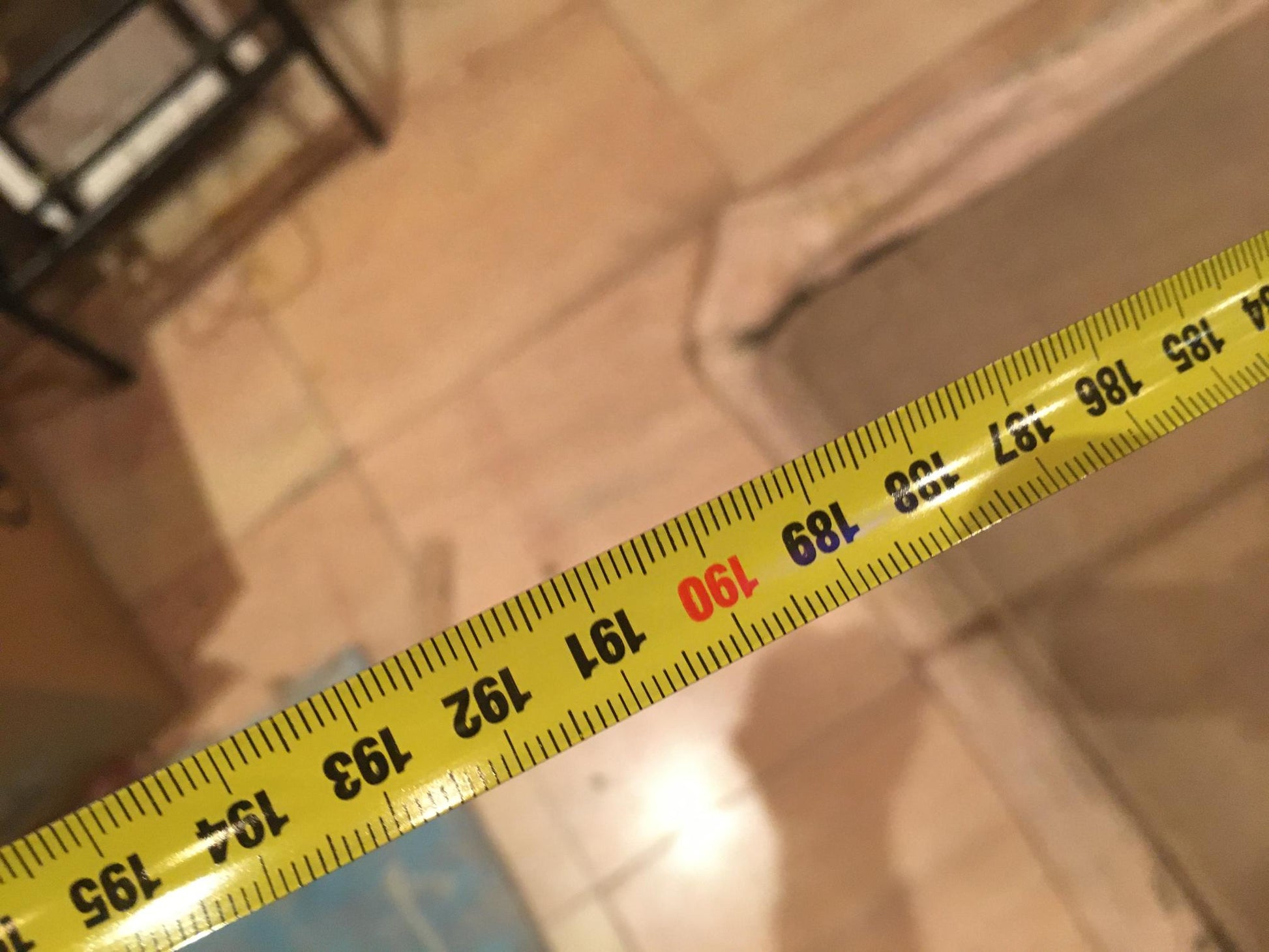Yellow tape measure with black and red markings in Oil painting Graduation