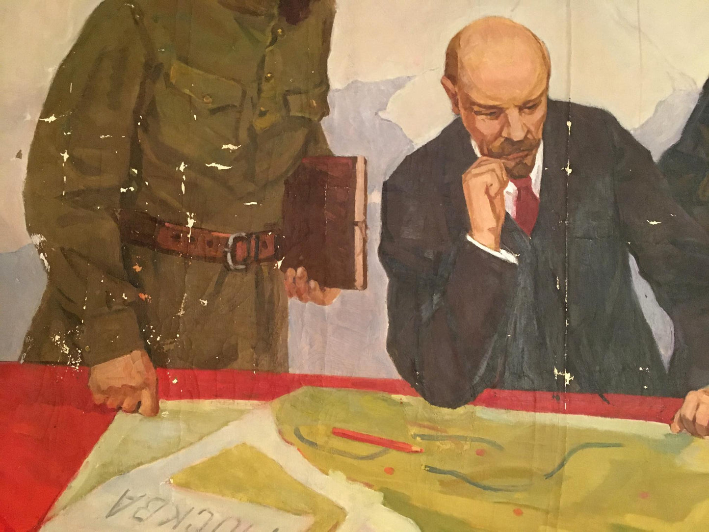 A painted mural depicting a man in a dark suit and red tie, with his hand resting on his chin as he examines a map.