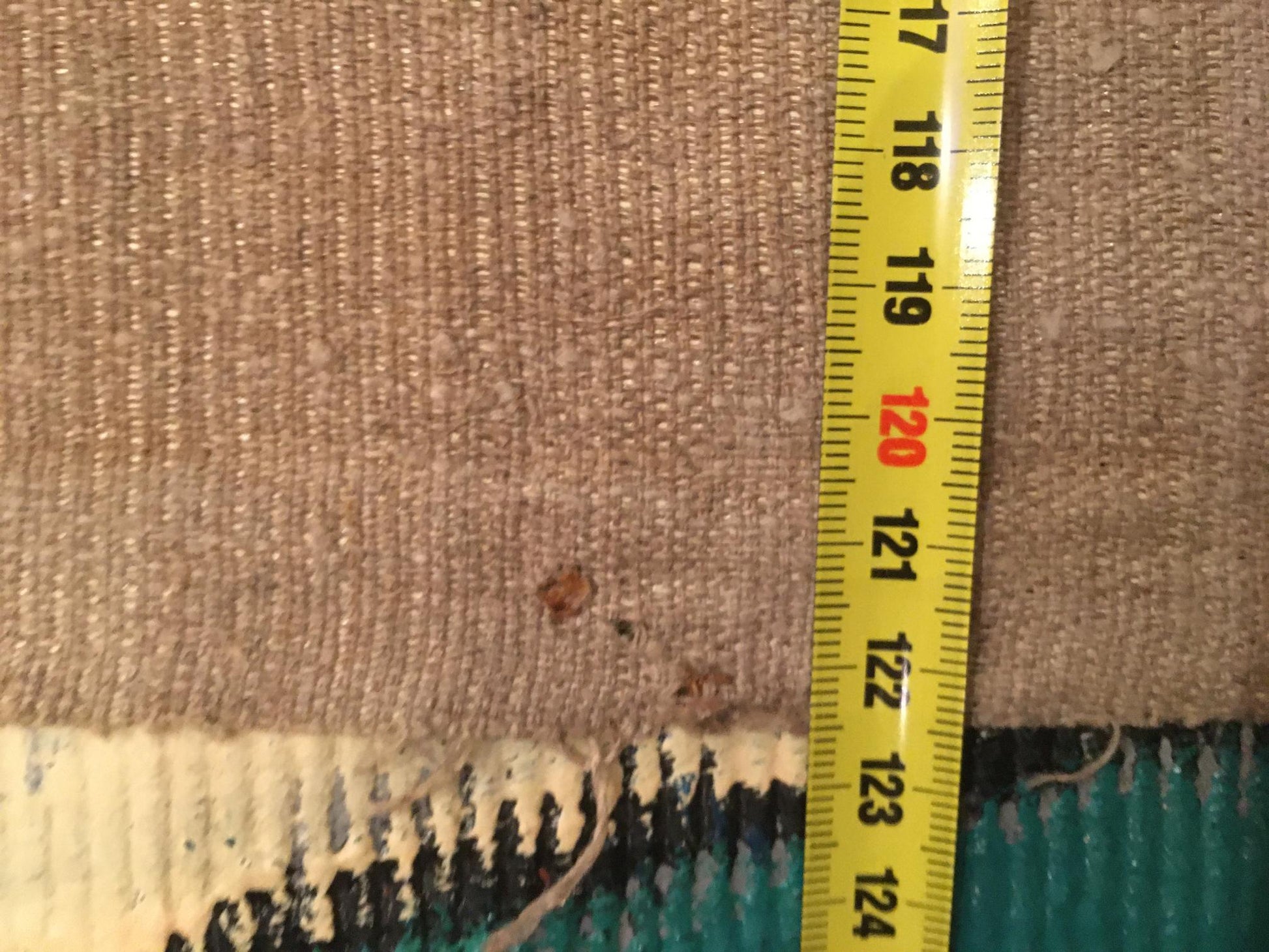 Back of Serov Lenin Party oil painting on frayed beige woven carpet