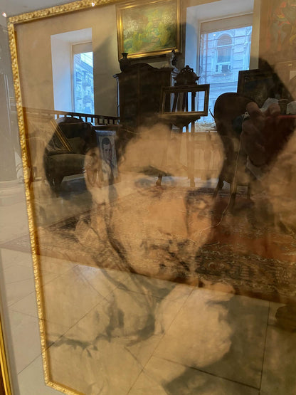 Gold-framed Repin portrait mirror with distorted room reflections