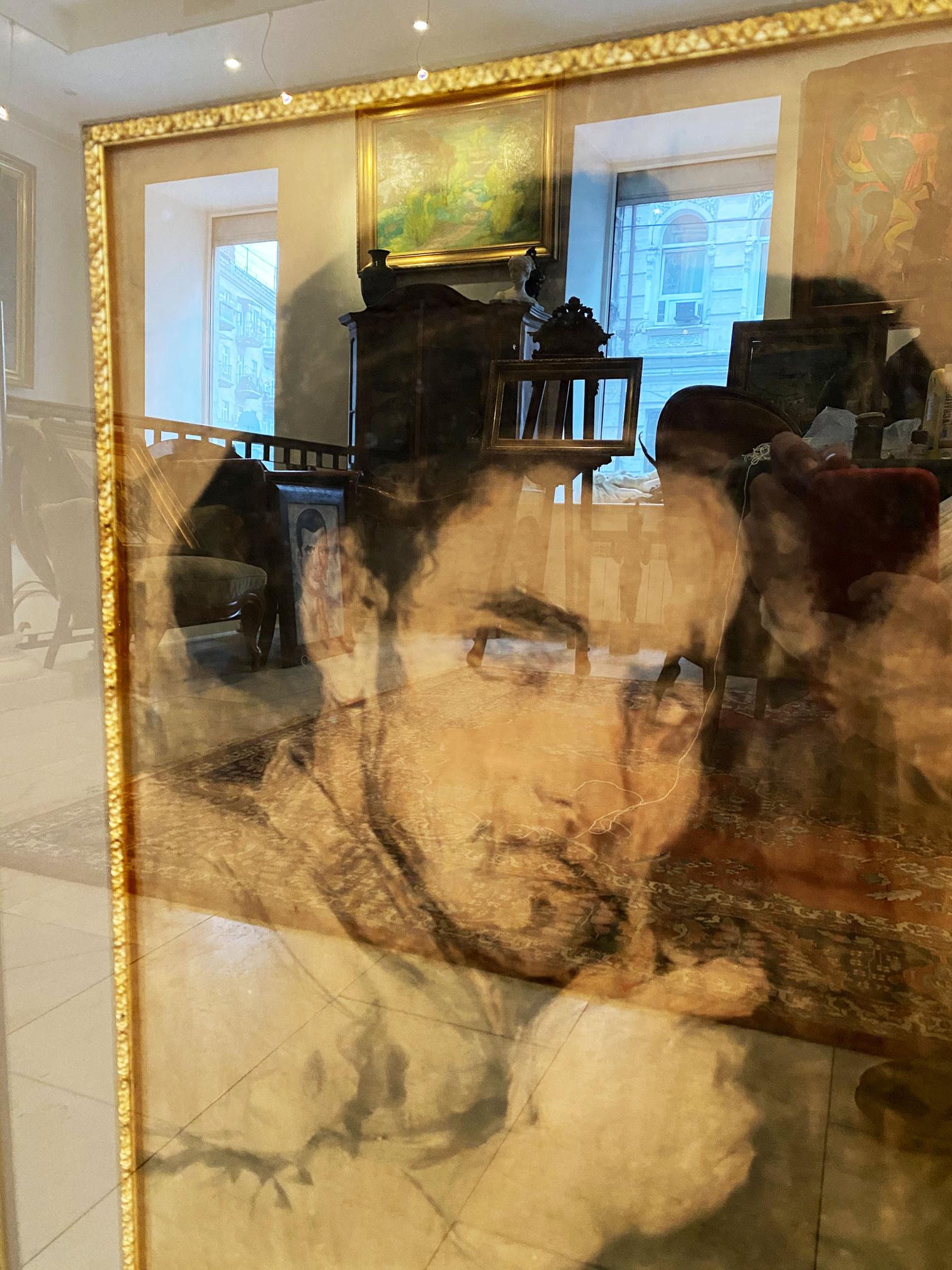 Sepia-toned portrait of a man by Ilya Efimovich Repin in ornate gold frame