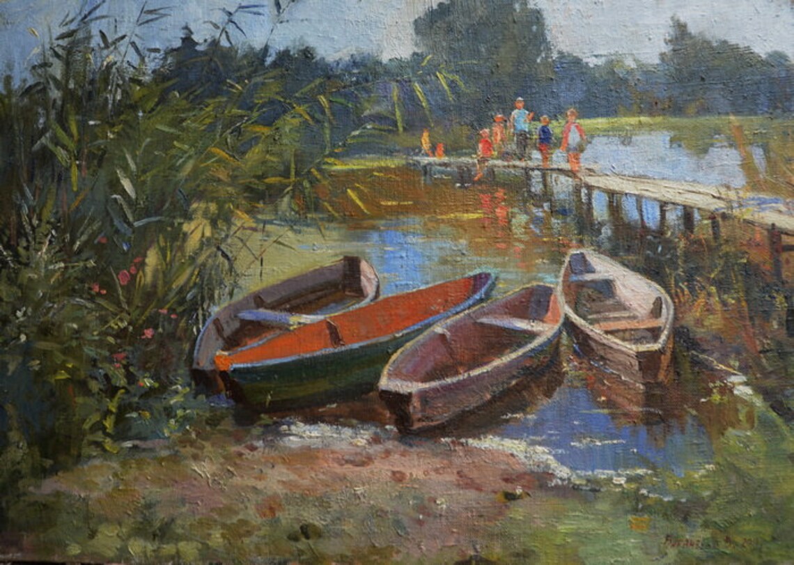 Three wooden rowboats with red and green painted interiors by Sothebys artist on waters edge