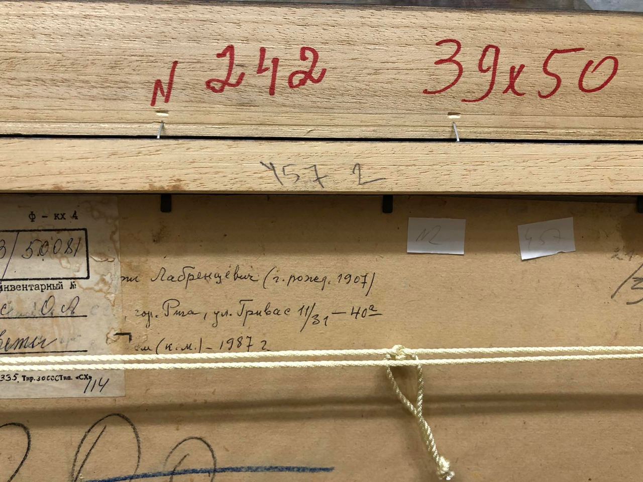 Back of Oil painting Flowers Olgert Jaunarajs with handwritten labels and red ink
