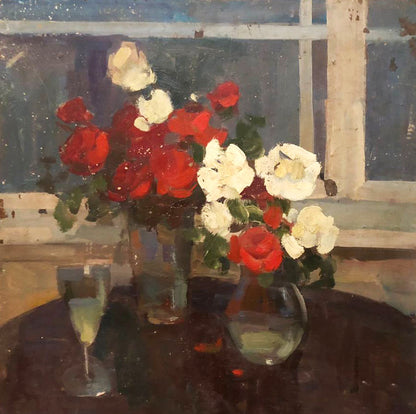 Oil painting of vibrant red and white roses in glass vase by window
